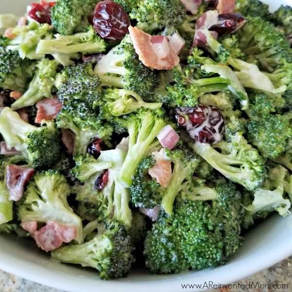 Closeup view of Broccoli Salad in a white bowl.