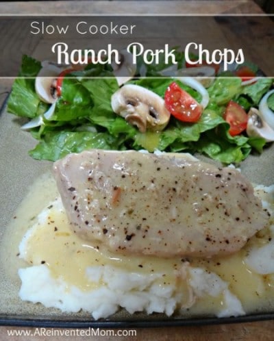 Crockpot ranch pork chop with gravy on a mashed potatoes with a green salad and text overlay.