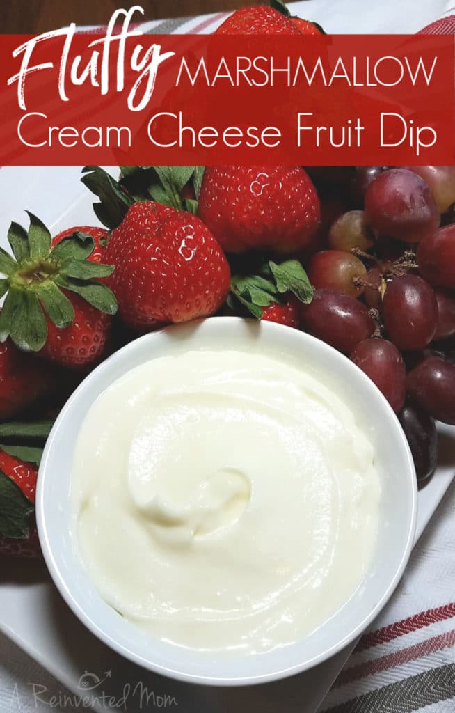 White bowl of fluffy Marshmallow Cream Cheese Fruit Dip served with strawberries & grapes with graphic overlay