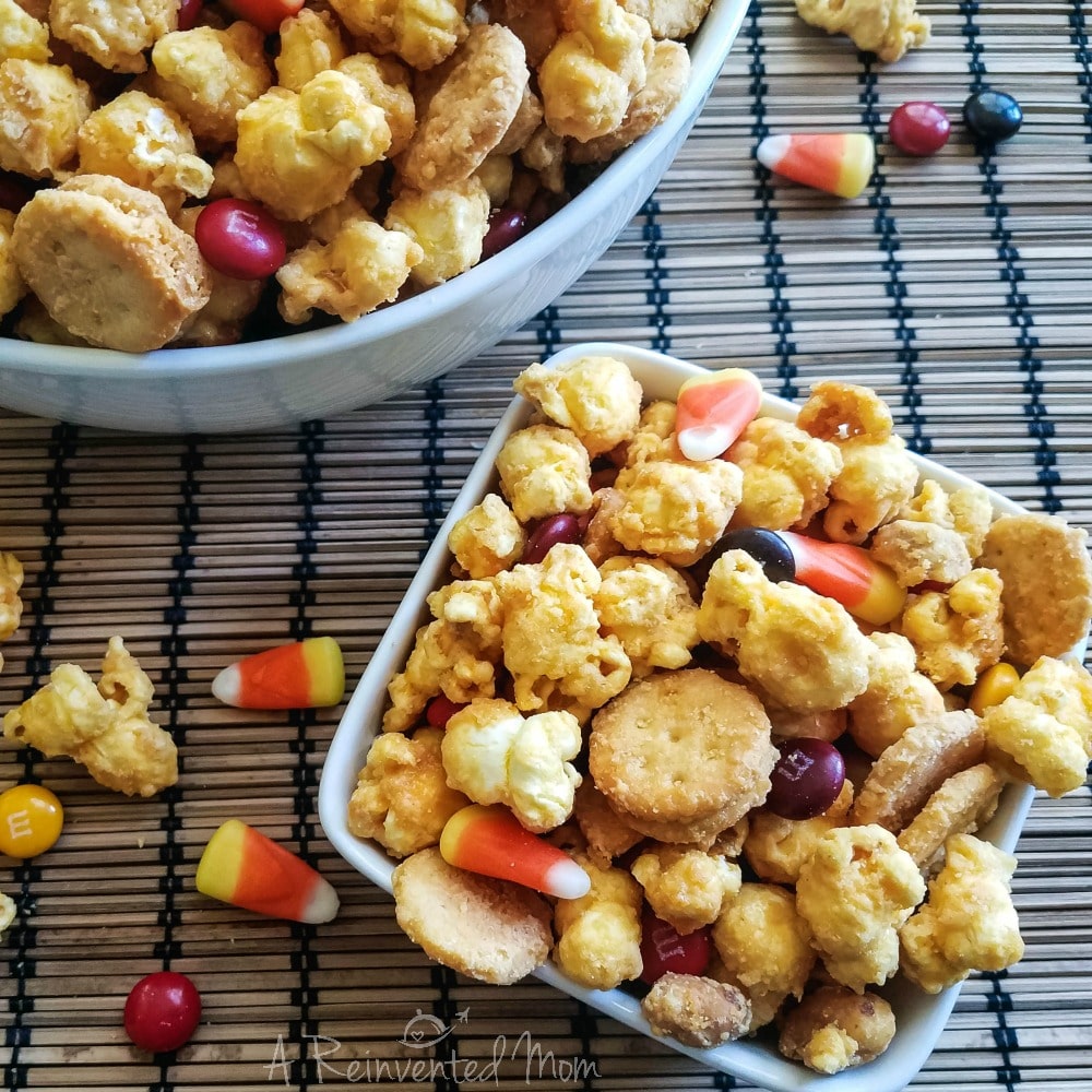 Small bowl of Halloween snack mix on a bamboo mat | A Reinvented Mom