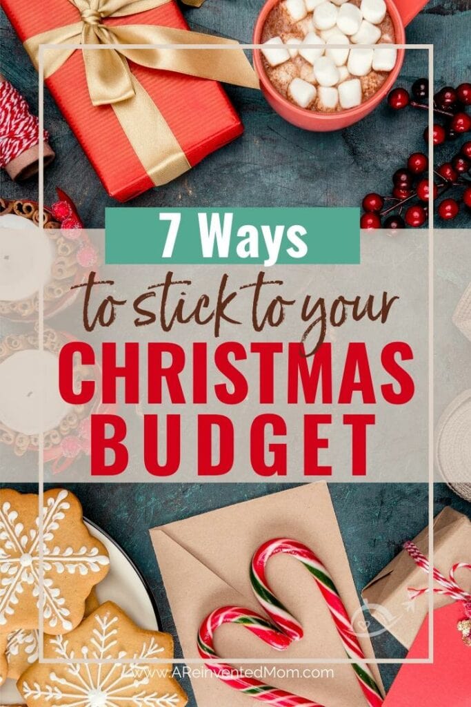 Wrapped presents, iced snowflake cookies, red mug filled with hot cocoa & marshmallows. candy canes & holiday candles on a grey countertop. 7 Ways to Stick to Your Christmas Budget | A Reinvented Mom