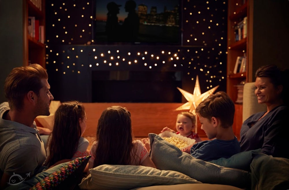 A family enjoying movie night at home at Christmas.