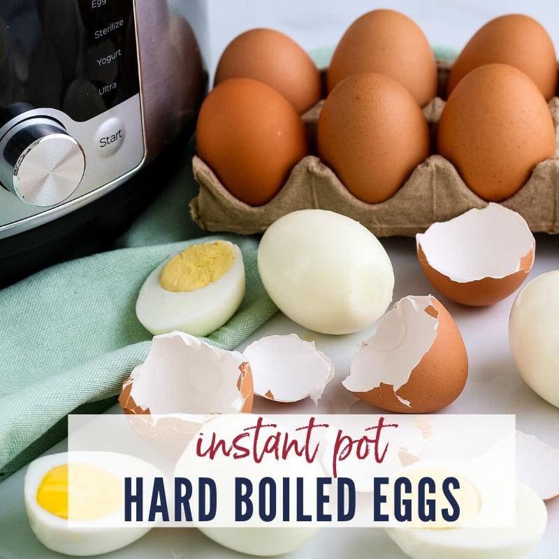 Close up view of hard boiled eggs on a counter top with carton of eggs, instant pot & a napkin.