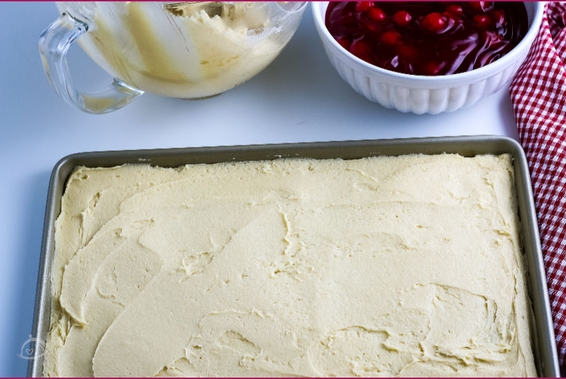 Crust in a baking pan with bowl of cherry pie filling in background | A Reinvented Mom