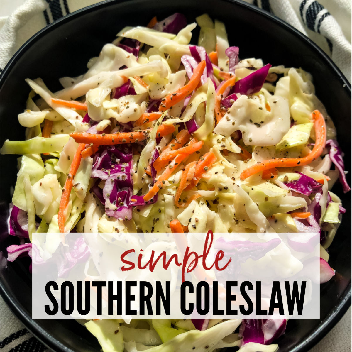 top view of southern coleslaw topped with black pepper in a black bowl