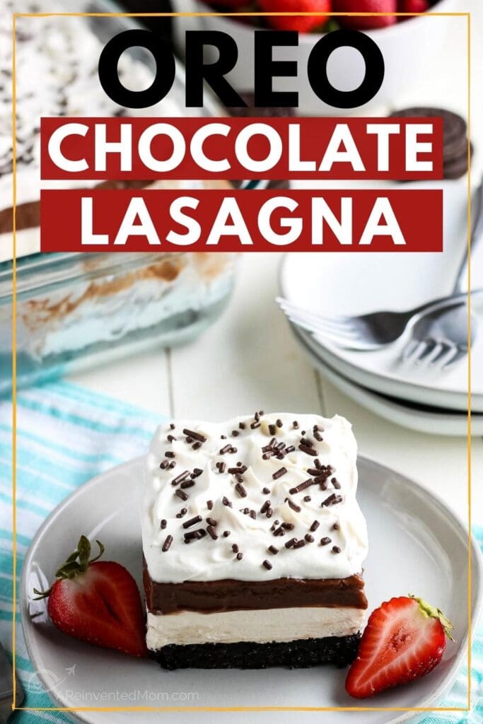Slice of Oreo Chocolate Lasagna on a white plate with sliced strawberries with graphic overlay.