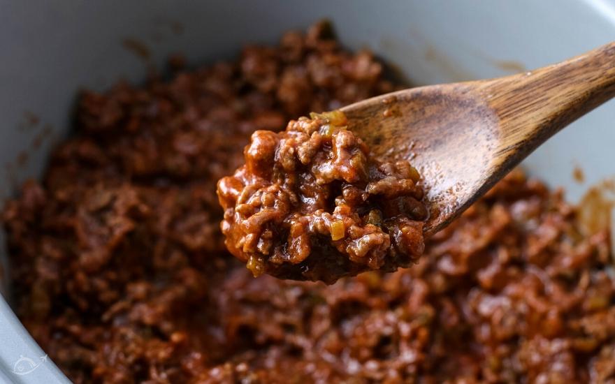 Homemade sloppy joe mix on a wooden spoon.