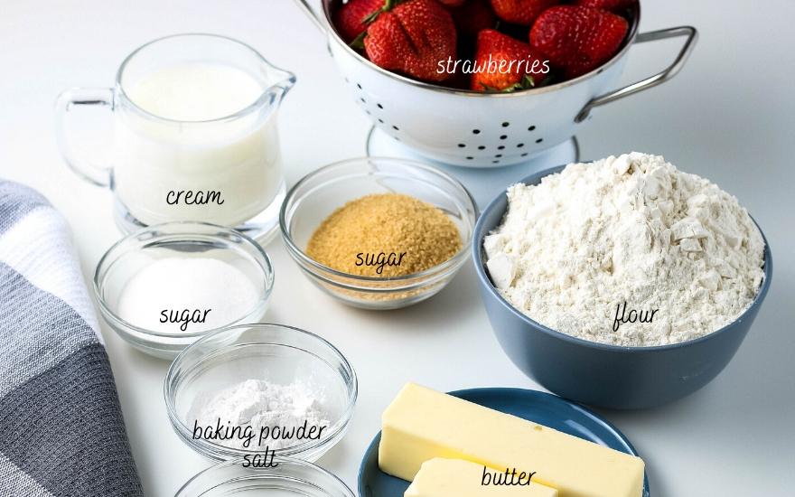 All ingredients set out ready to make strawberry shortcake with biscuits