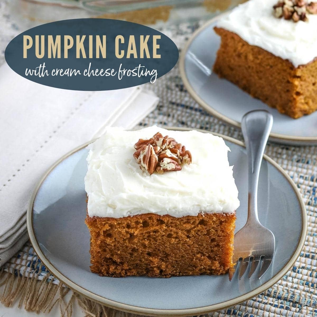 A slice of pumpkin cake with cream cheese frosting topped with chopped pecans on a blue plate with a fork next to another slice with text overlay.