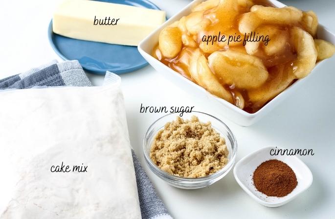 all ingredients for crockpot apple dump cake on a white counter