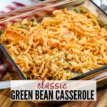 close up of green bean casserole topped with fried french onions in a glass dish with text overlay