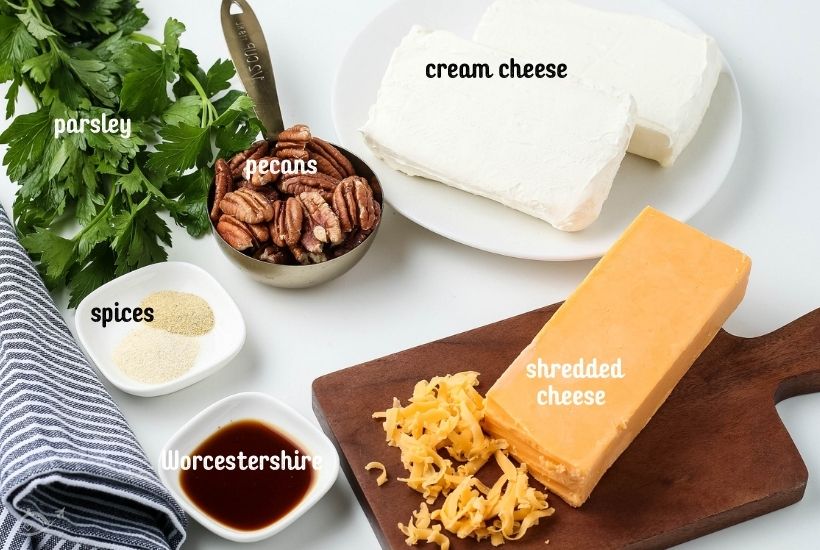 ingredients to make a classic cheese ball with the cheese on a cheese board