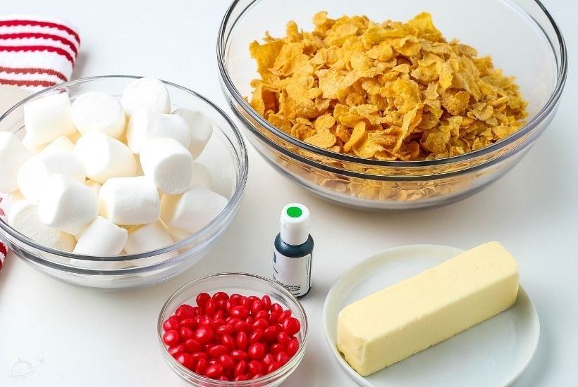 ingredients for cornflake wreaths in glass bowls on white counter 