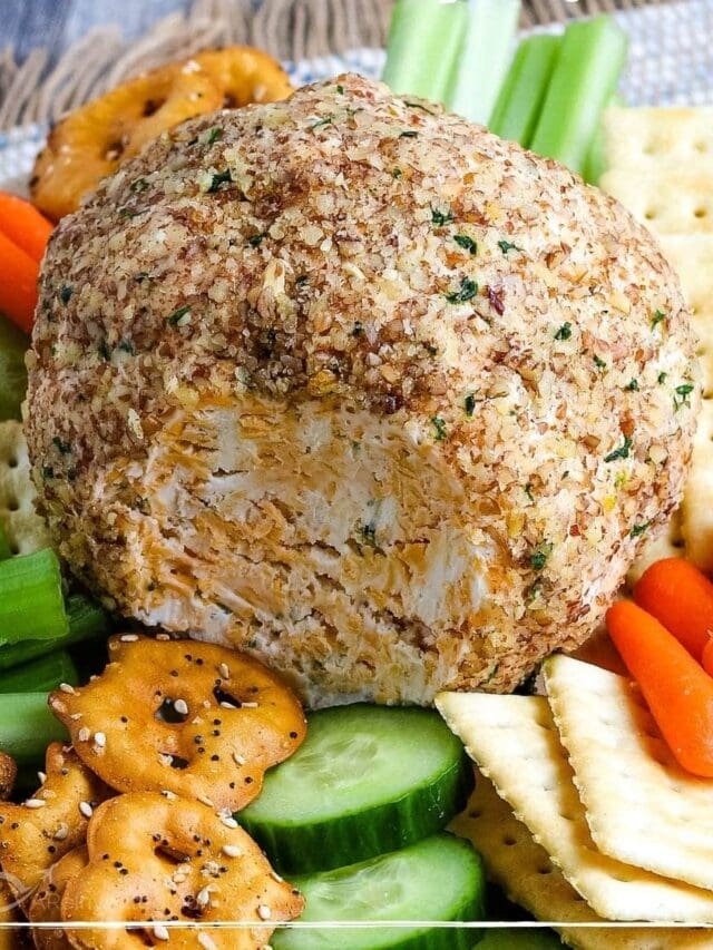 cheese ball next to crackers, pretzels, and cucumbers with text overlay
