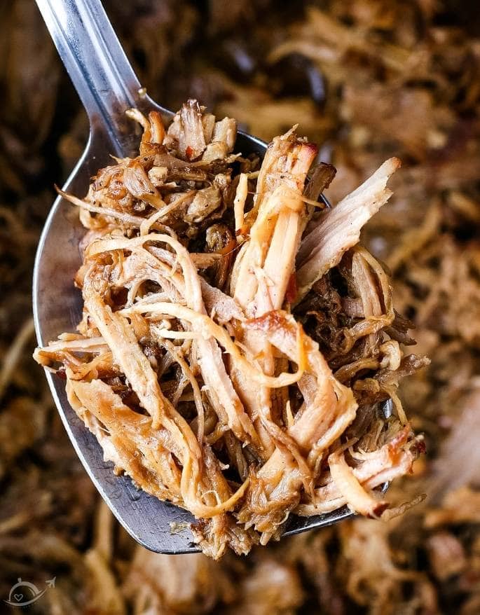 closeup of cooked pulled pork on a spoon