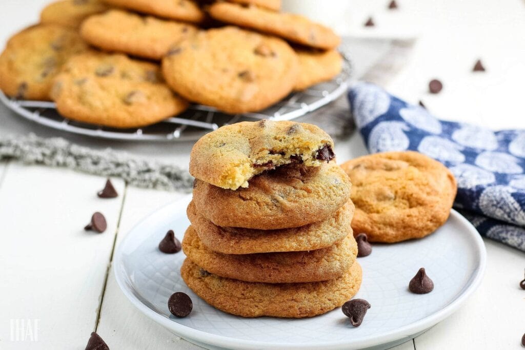 Stack of air fried chocolate chip cookies on a small white plate.