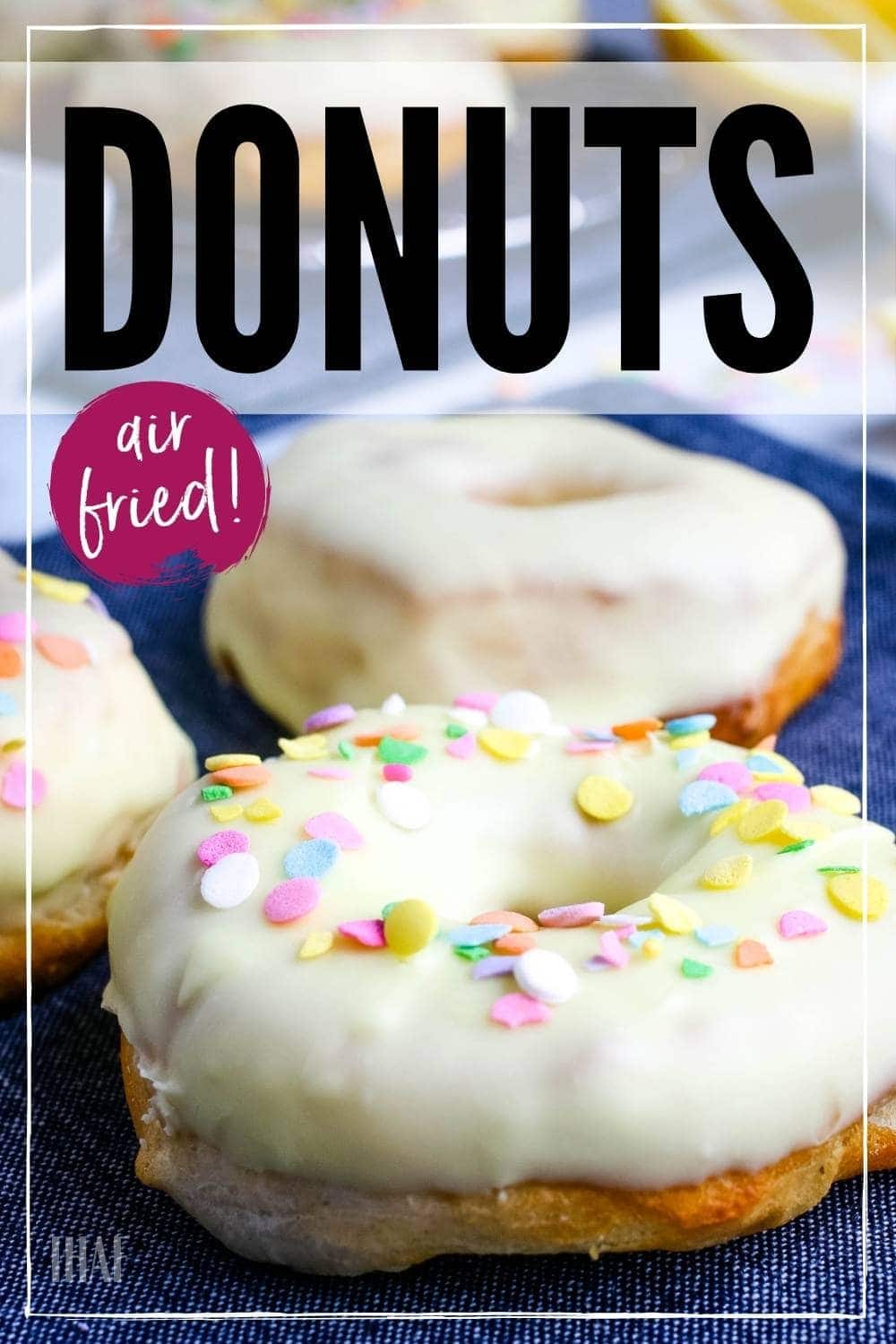 closeup of frosted donuts with sprinkles on blue napkin with graphic overlay