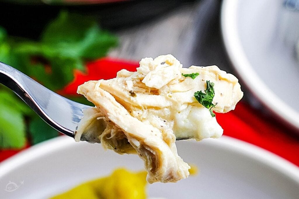 close up of instant pot mississippi chicken on a fork