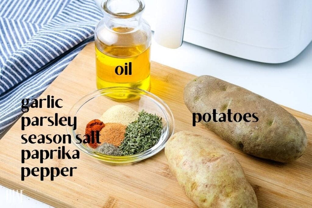 ingredients labeled on a cutting board for making diced potatoes in the air fryer