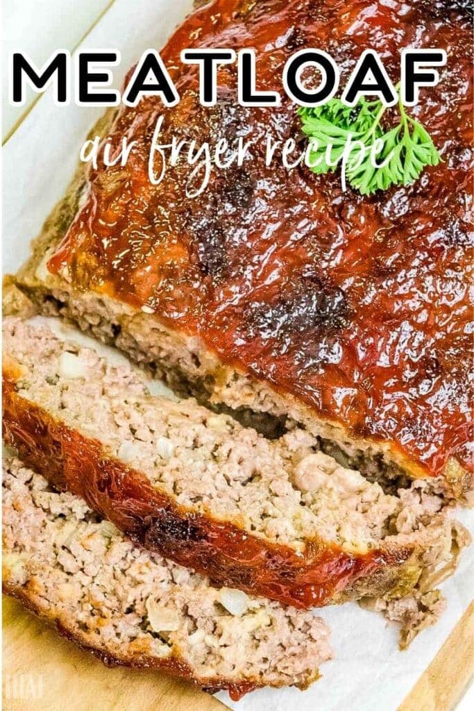 Air fryer meatloaf with 2 cut slices and topped with parsley with text overlay.