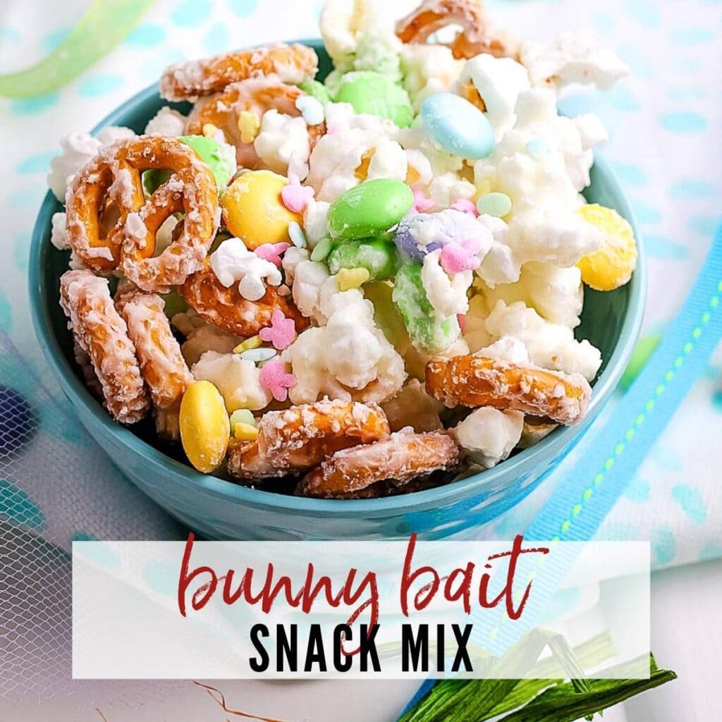 Closeup view of a blue bowl filled with Bunny Bait snack mix with text overlay.