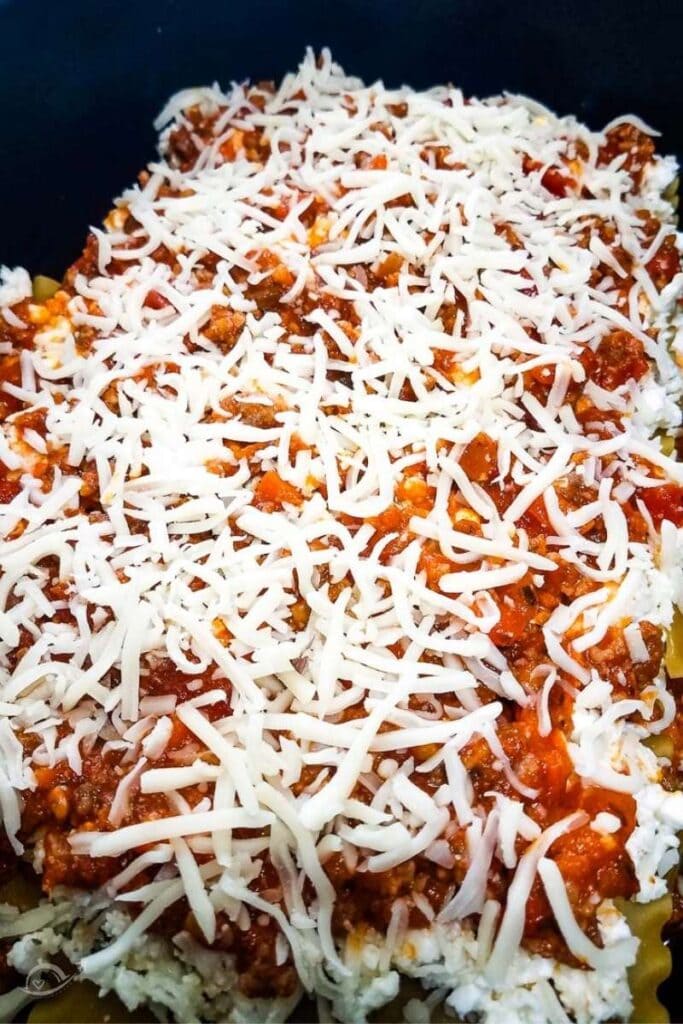 closeup view of uncooked lasagna in crockpot