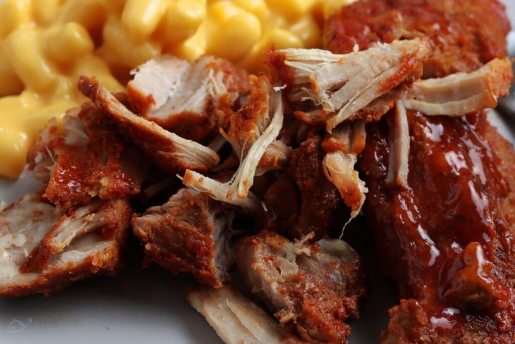 close up of instant pot country ribs next to mac and cheese