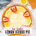 Overhead view of a no bake lemon icebox pie garnished with lemon slices and strawberries with text overlay.