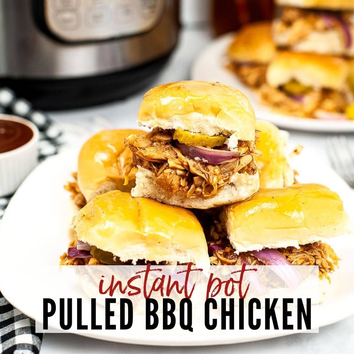 stack of instant pot pulled bbq chicken sliders on a white plate with text overlay