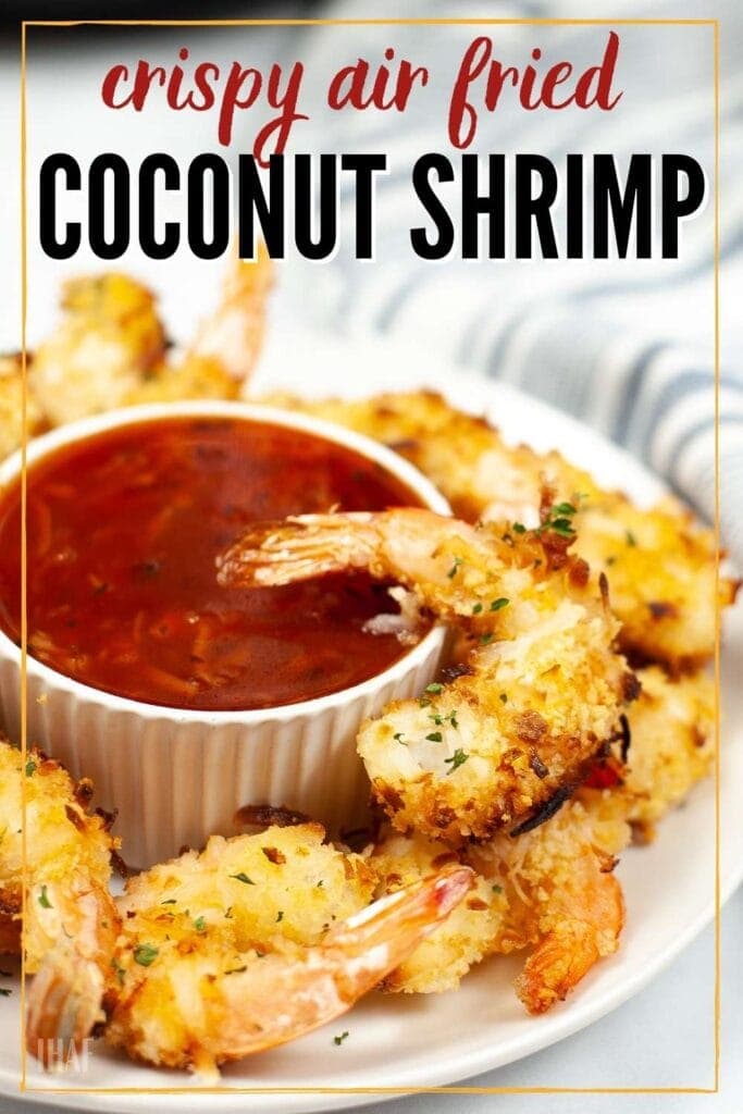 crispy air fryer coconut shrimp with a ramekin of red sauce in the middle with text overlay