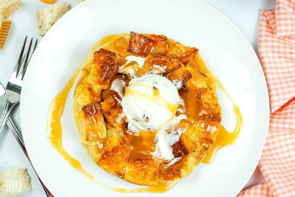 Overhead view of air fryer bread pudding with a scoop of vanilla ice cream.