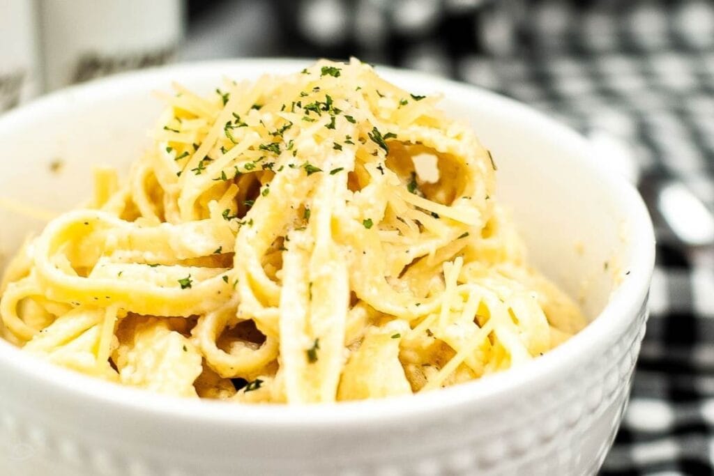 close up of fettuccine Alfredo pasta in a small white bowl