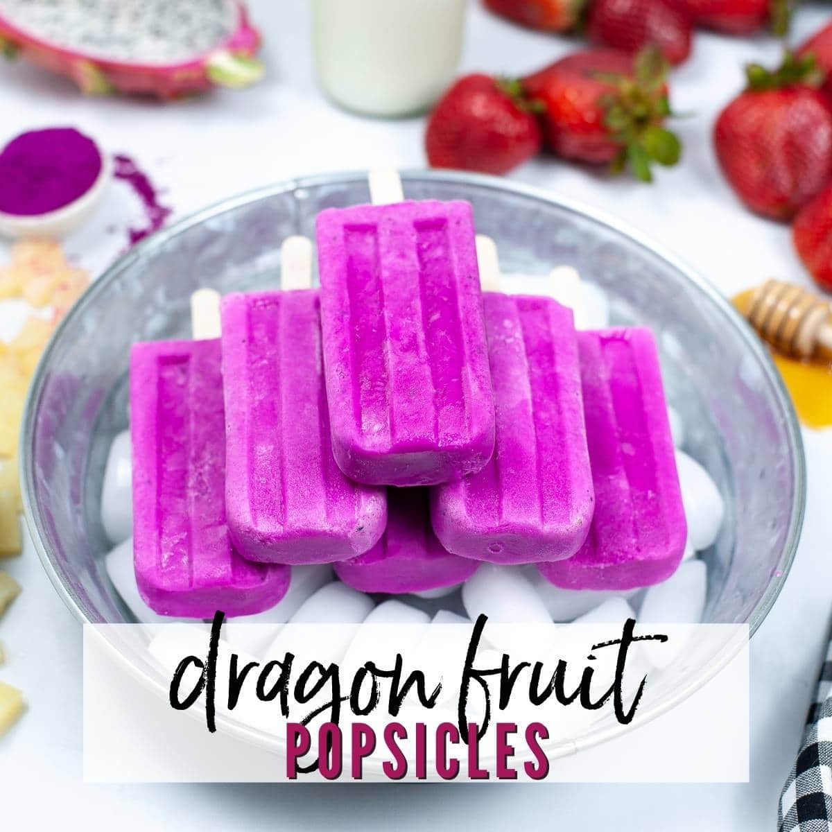 top shot of a batch of dragon fruit popsicles on ice in a galvanized tub with text overlay