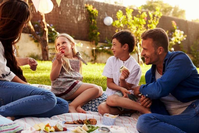 family enjoying a picnic in their backyard