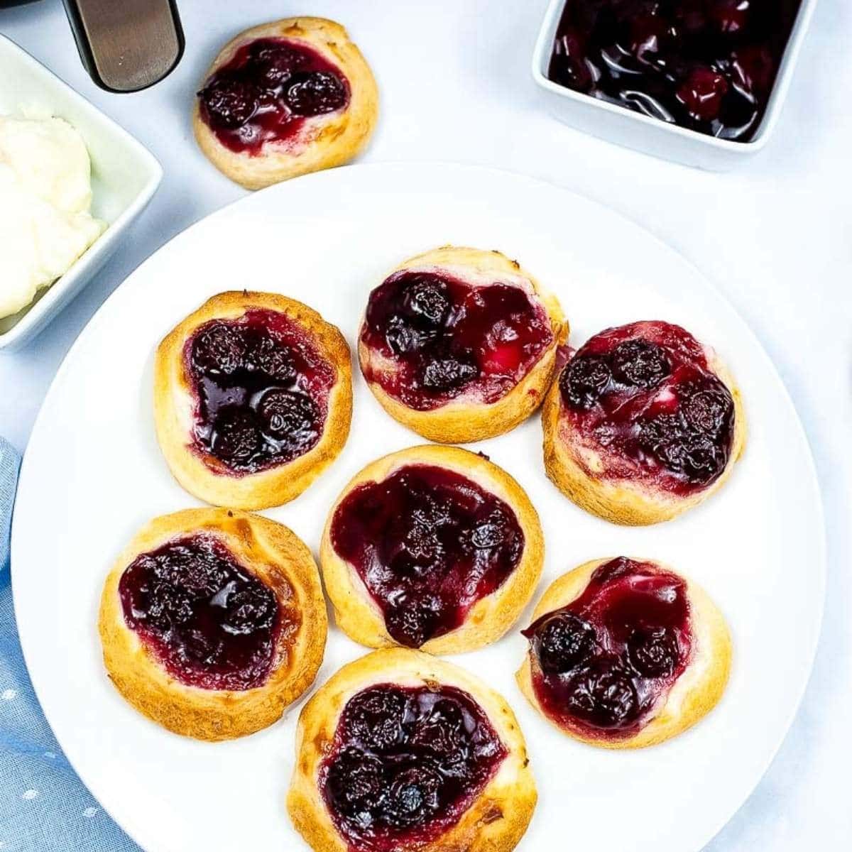 top view of air fried cherry cheese danishes on a white plate