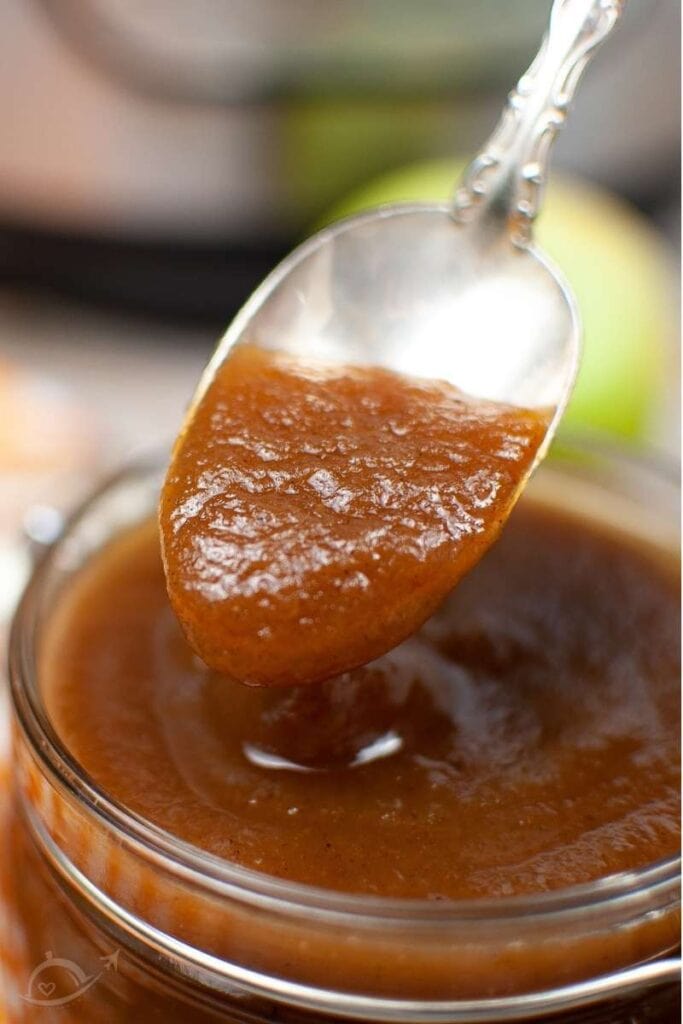 apple butter on a spoon after being cooked in the instant pot