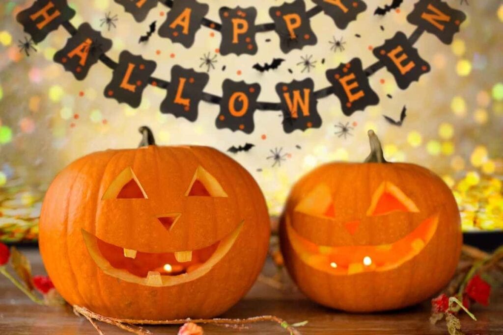 carved jack o lanterns with a halloween banner in the background