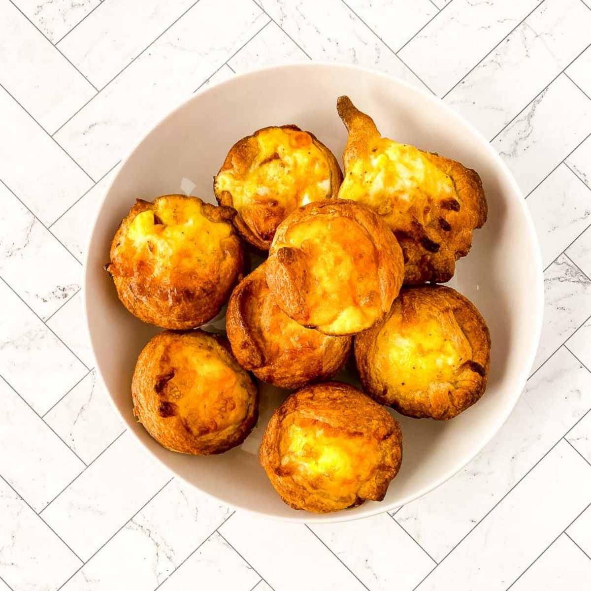 top shot of crescent roll quiche bites in a white bowl