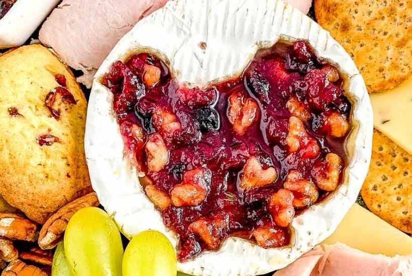 Close-up view of the cranberry brie wheel placed on the charcuterie board.