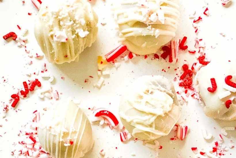 close up of peppermint cake balls with broken peppermints on top.