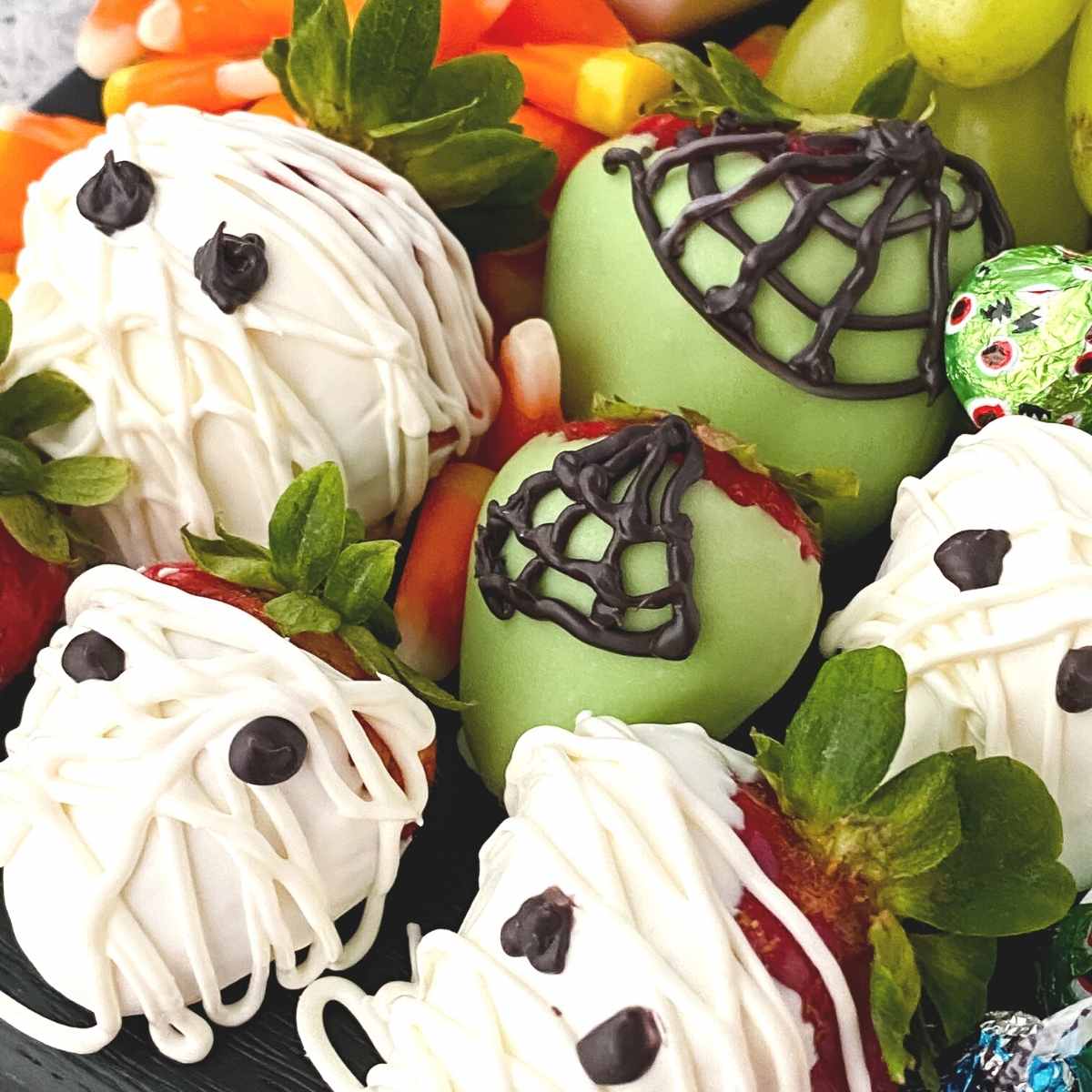 close up of mummies and spider chocolate covered strawberries for Halloween