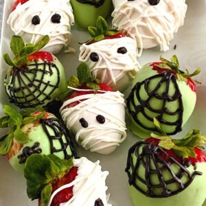 close up of mummies and spider chocolate covered strawberries for Halloween