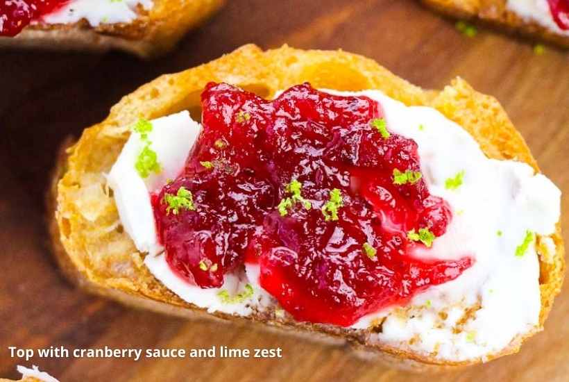 close up of cranberry crostini with lime zest and cream cheese