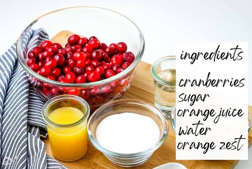 ingredients to make homemade cranberry sauce on a wooden board with text label