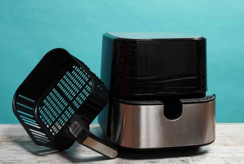 air fryer with basket sitting next to it