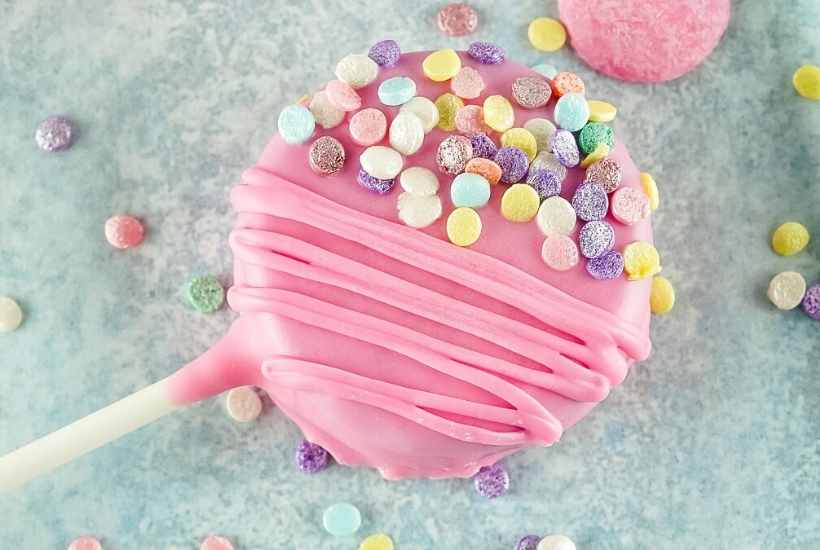 top shot of a valentines day cookie pop decorated with pastel colored sprinkles