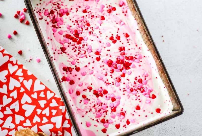 a pan filled with frozen ice cream topped with Valentine's sprinkles