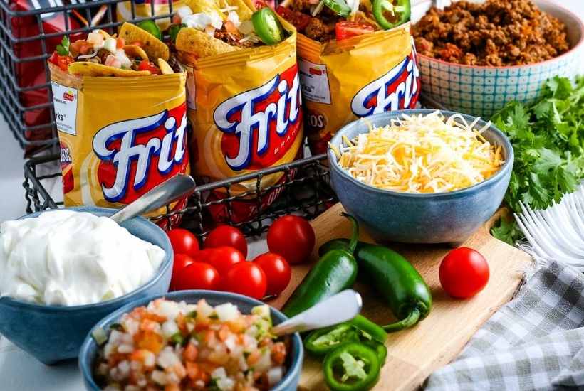 close up of walking tacos next to toppings