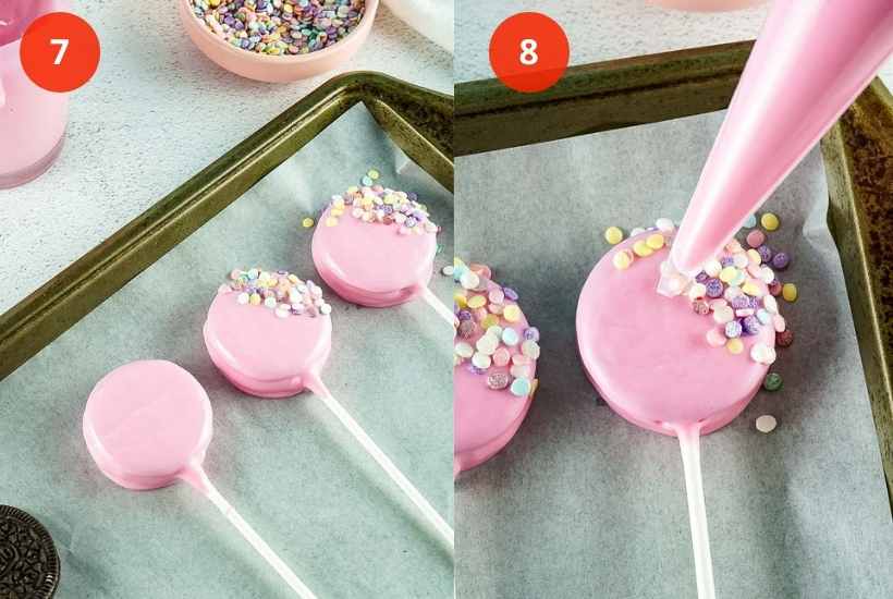 Pink chocolate covered oreo cookie pops with sprinkles drying on a baking sheet.
