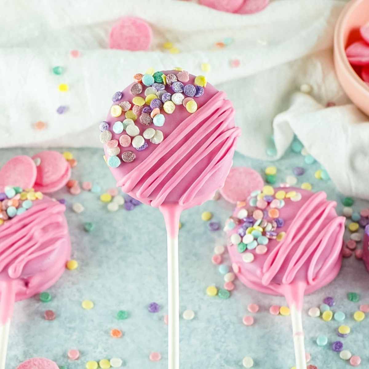 Closeup of valentines day oreo pops dipped in pink chocolate.